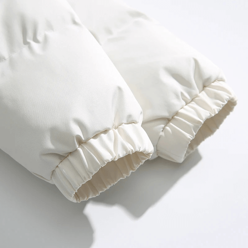 Close-up of sleeves on a warm hooded zipper jacket with patchwork detailing, showcasing trendy puffer style and elegant broadcloth fabric.